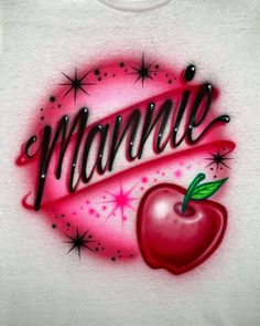 a white shirt with an apple and the word mama written in cursive writing