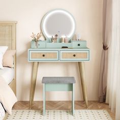 a bedroom with a bed, dresser and mirror on it's side table in front of a window