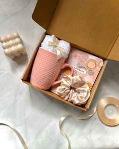 an open box with some items in it on a white counter top next to other objects