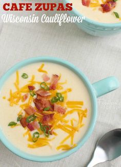 two bowls of soup with bacon, cheese and green onions in them on a table