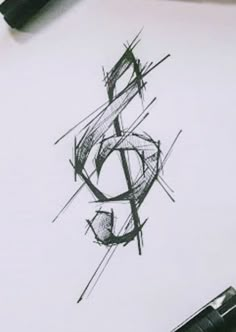 a pen drawing a musical note on top of a piece of paper with some ink