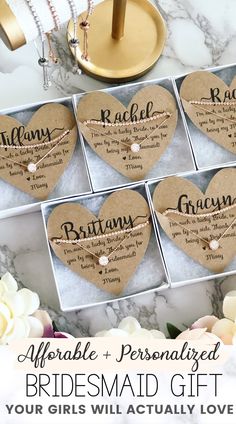 the bridesmaid gift box is filled with personalized heart shaped tags and pearls