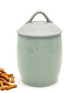 a dog paw print on the side of a ceramic container next to some dry food