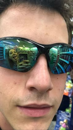 a man wearing sunglasses with the reflection of himself in it's glasses and text just me and bae