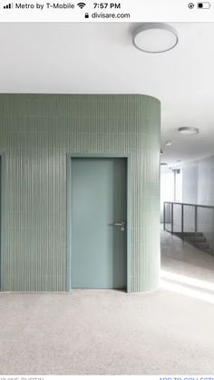 an empty room with green walls and doors