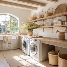 a washer and dryer in a room with open shelves on the wall above them