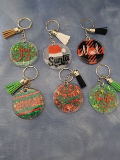 six key chains with different designs on them