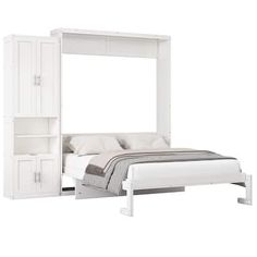 a white bed sitting under a mirror next to a night stand and bookcases