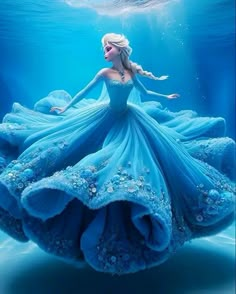 a woman in a blue dress under water