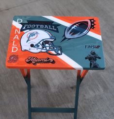 an orange and blue side table with football logos on it