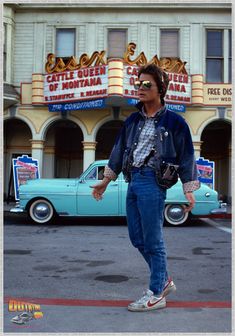 a man standing on the street in front of a building