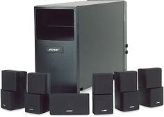 a computer tower with several speakers and one subwoofer in front of it