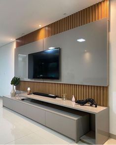 a flat screen tv mounted to the side of a wall in a modern living room