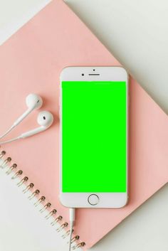 an iphone and earphones on a pink notebook