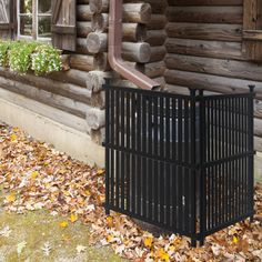 an old log cabin with a metal gate and window on the front porch in autumn