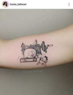 a woman's arm with a sewing machine tattoo on it