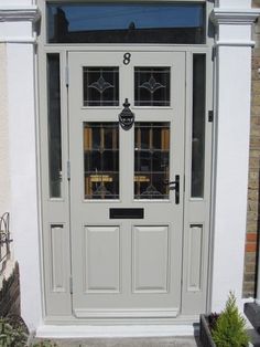 the front door is painted white and has glass panels