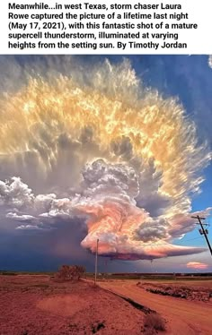 a large cloud is in the sky above a dirt road