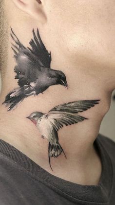 a man with a bird tattoo on his neck