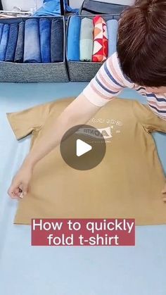 a young boy is making a t - shirt out of fabric