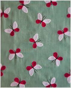 red and white butterflies on green fabric