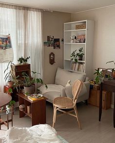 a living room filled with furniture and plants