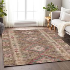 a living room with a couch, chair and rug on the floor in front of a window