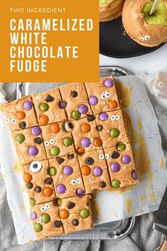 two ingredient caramelized white chocolate fudge with candy eyes on top and halloween cookies in the background