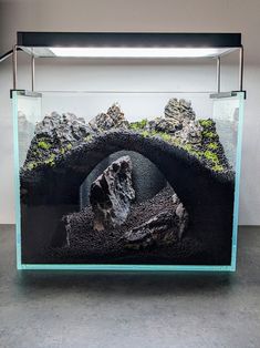 an aquarium with rocks and water inside