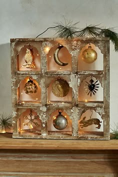 an assortment of ornaments are displayed on a mantel