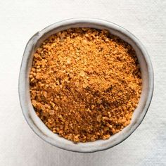 a bowl filled with some kind of food on top of a white table cloth,