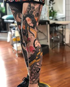 a woman's legs with tattoos on them