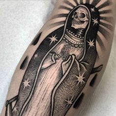 a black and white image of the virgin mary with stars on her arm is shown