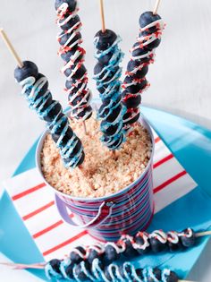 an image of desserts on sticks in a cup