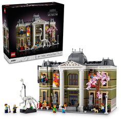 a lego set in the shape of a building with people standing outside and inside it