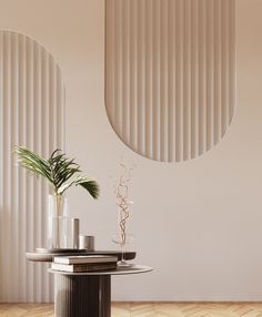 two vases and a plant on a table in front of a wall with vertical blinds