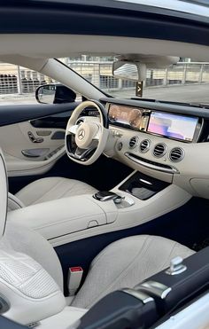 the interior of a mercedes s - class coupe with its dashboard and infotain visible