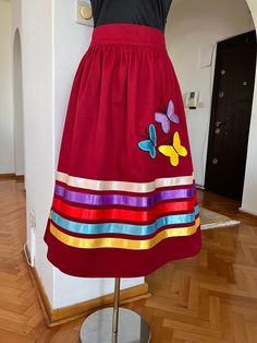 a dress on a mannequin in a room with wooden floors and white walls