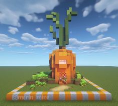 an orange building with cactus on top in the middle of a field