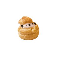 a pastry with cream and black dots on it's face, sitting in front of a white background