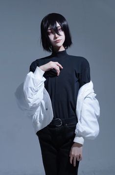 a woman in black and white is posing for the camera with her hand on her hip