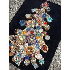 a black rug covered in lots of different types of brooches