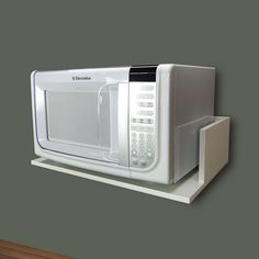 a white microwave oven sitting on top of a shelf