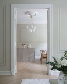 a room with white walls and wood floors