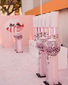 some pink candy machines are lined up on the floor