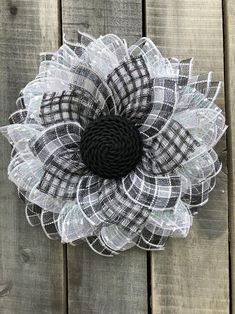 a black and white flower on a wooden surface