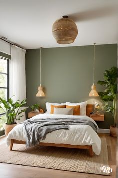 a bedroom with green walls, white bedding and hanging lights over the headboard