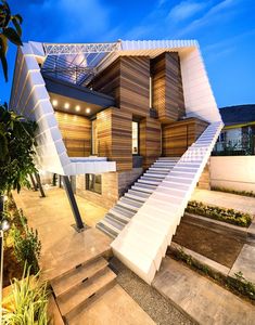 a modern house with stairs leading up to it