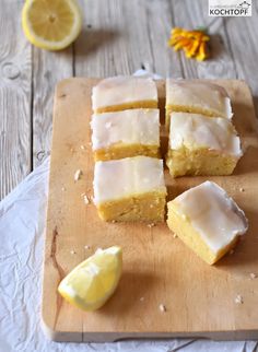 lemon bars are cut into squares on a cutting board