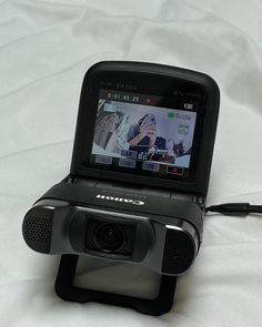 a small camera sitting on top of a bed